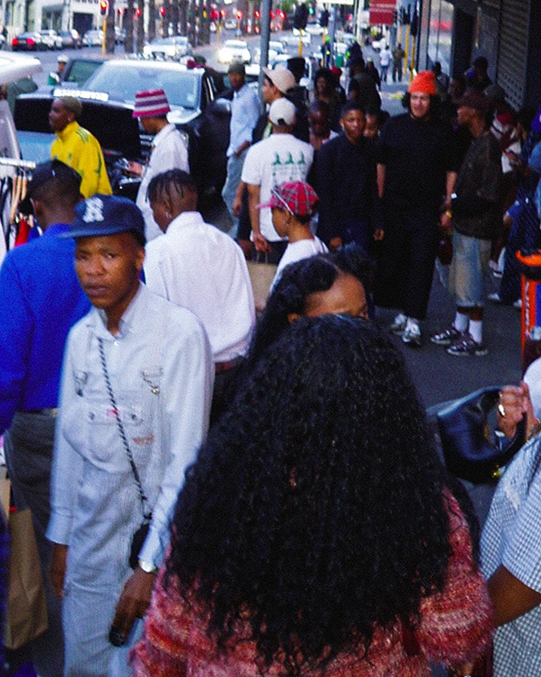 Crowd of people on a busy street with various activities