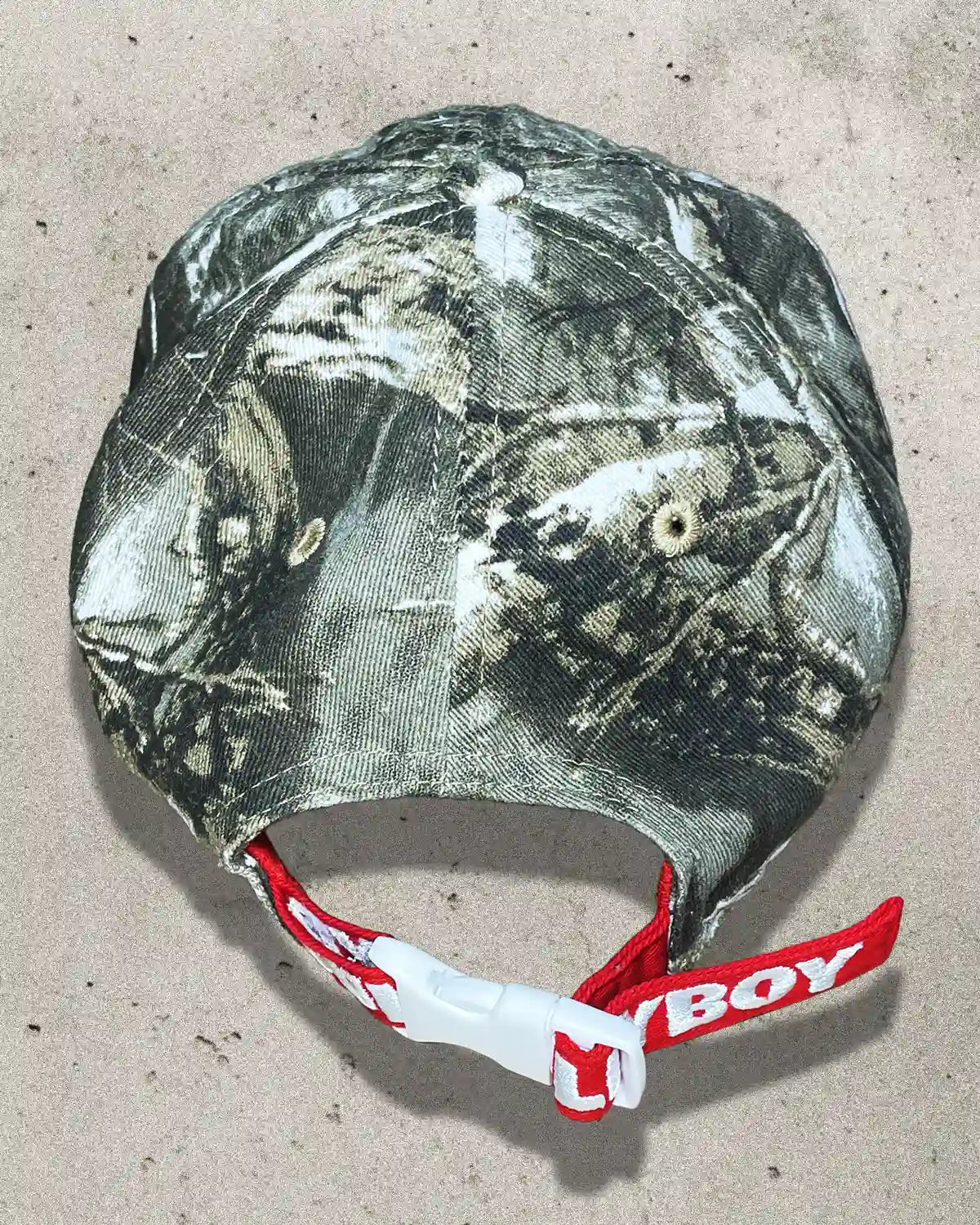 Back view of camo Bullyboy cap featuring red strap with white Bullyboy embroidery and white clamp