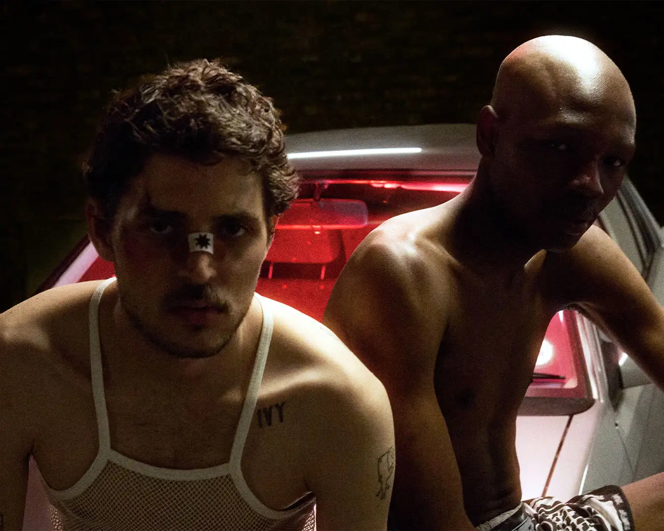 to men sitting on the bullyboy car posed after a boxing match