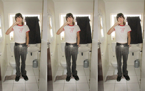 Stylish man brushes his teeth in a small apartment bathroom in Cape Town while wearing the new bullyboy tee
