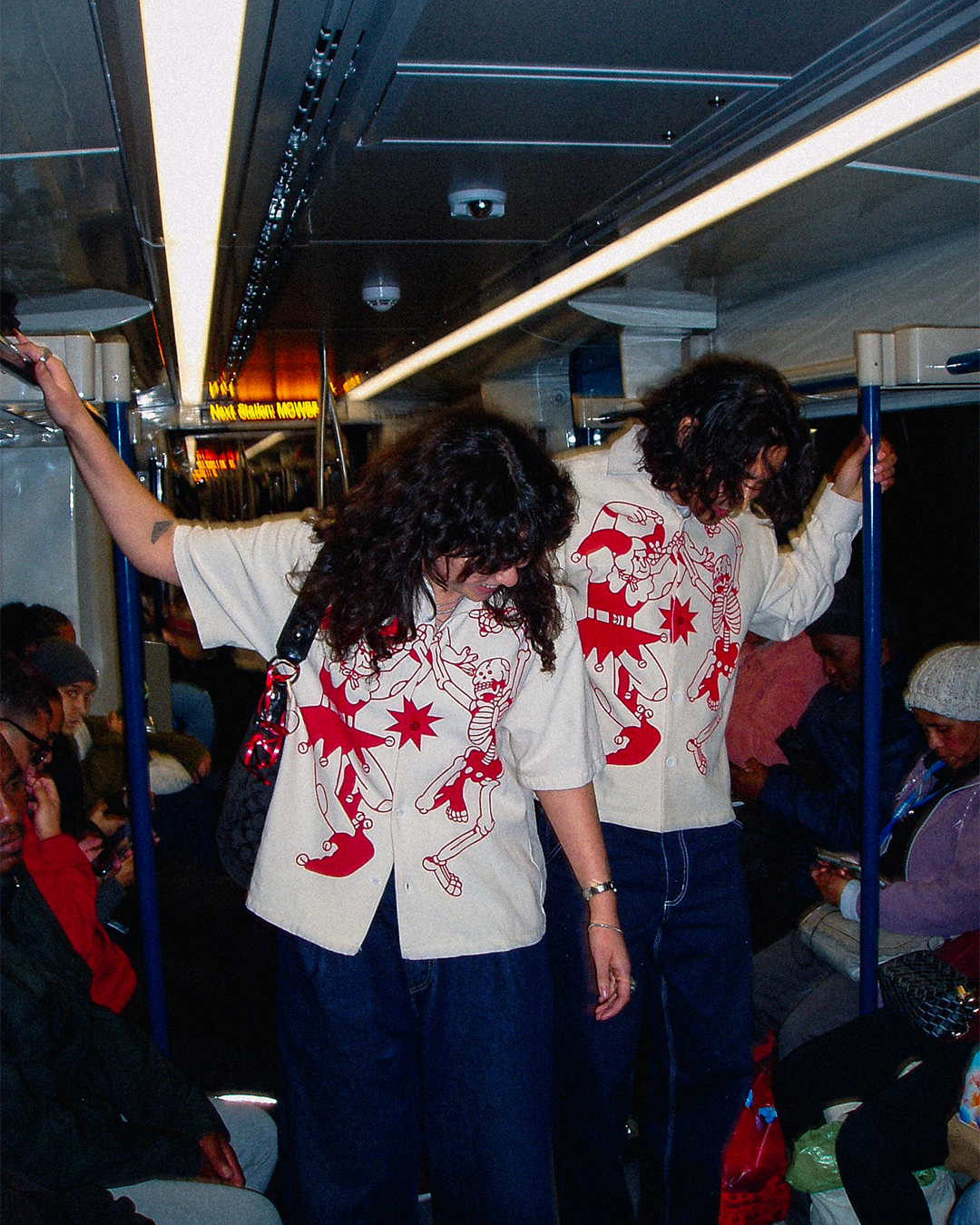A trendy couple in a packed train in Cape Town wearing the newest Bushy Wopp heavy duty button up shirts