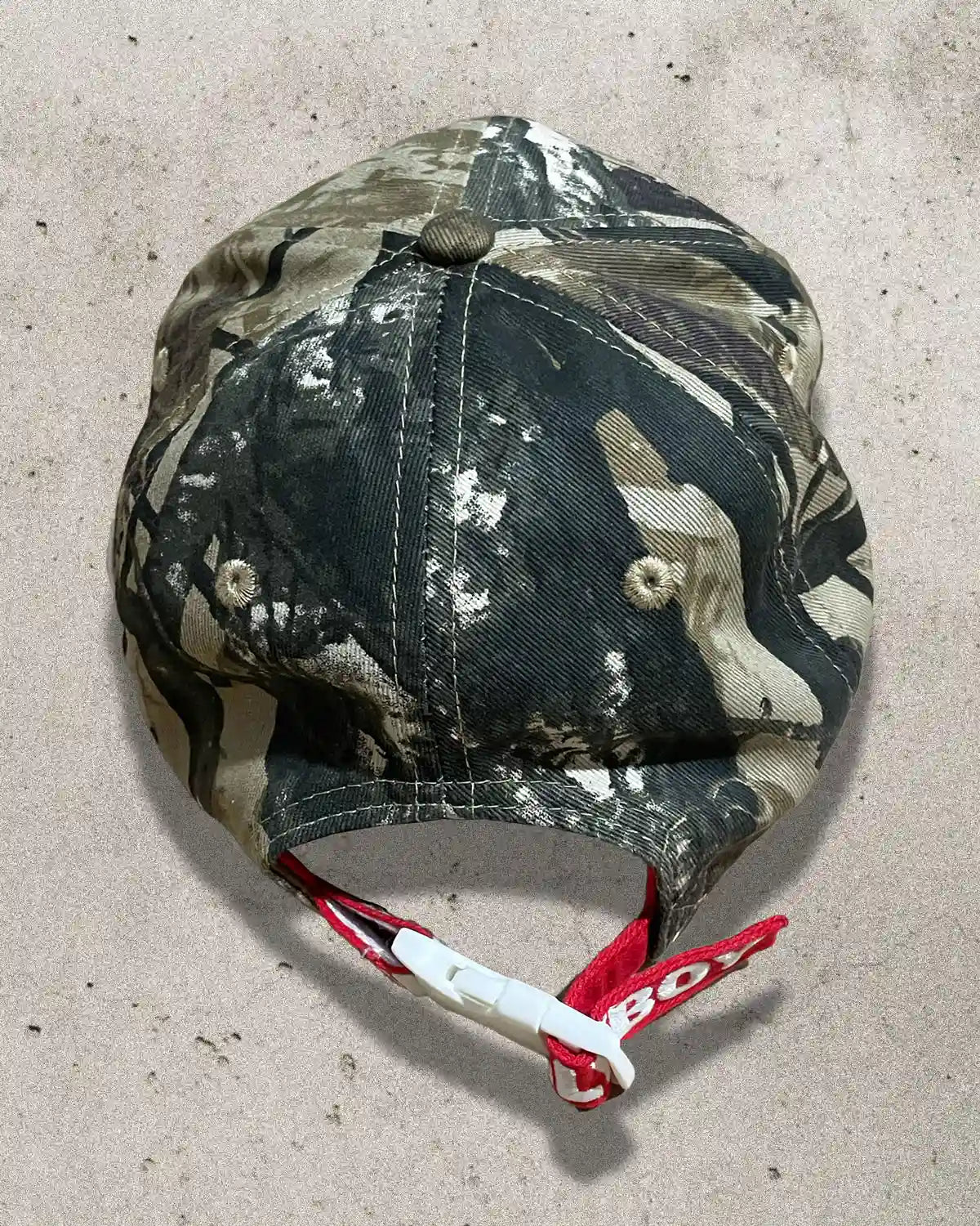 One-off camo hat combining grunge aesthetic with divine messaging.