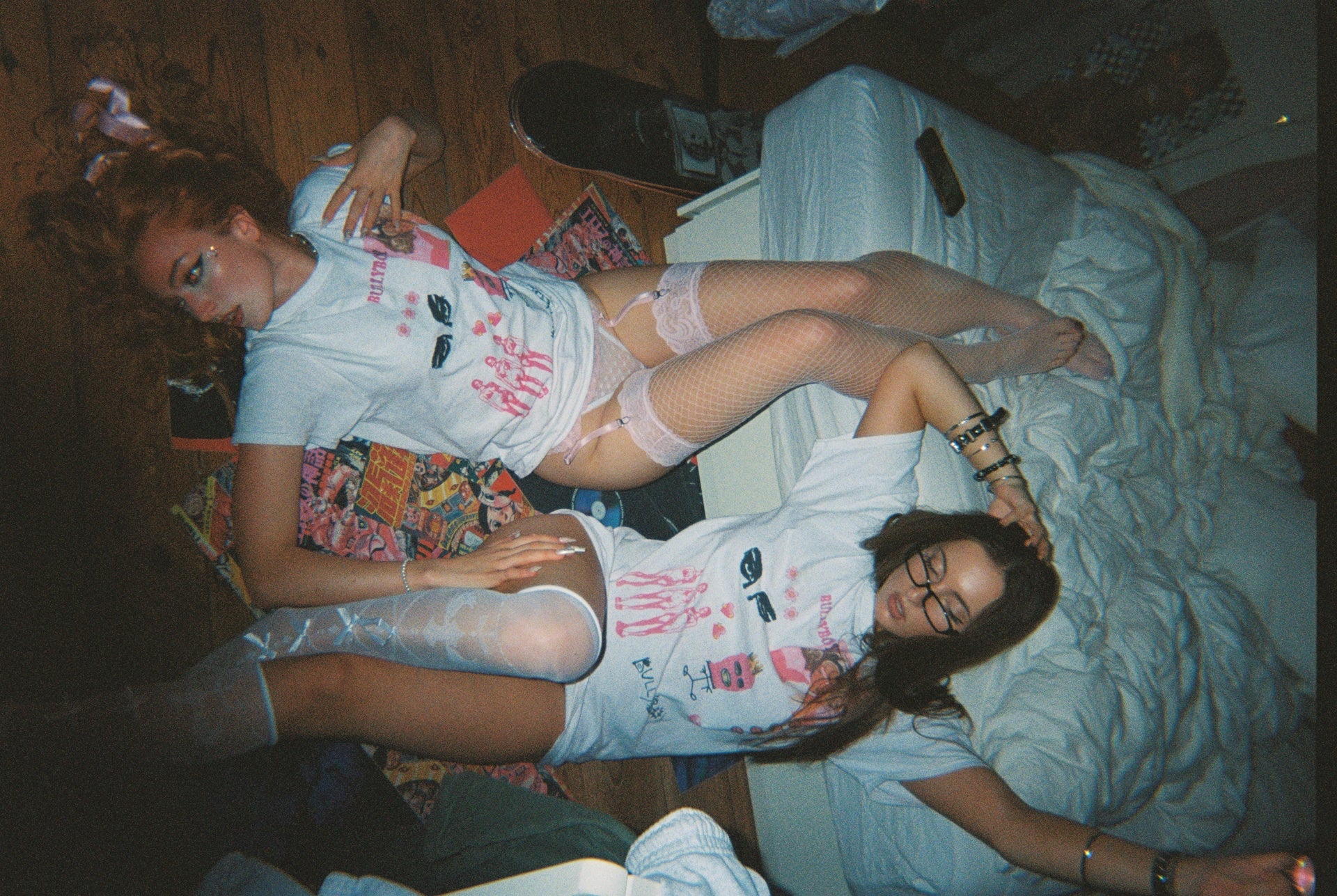 Bullyboy models lying down in a bedroom while wearing the Bullyboy t-shirts