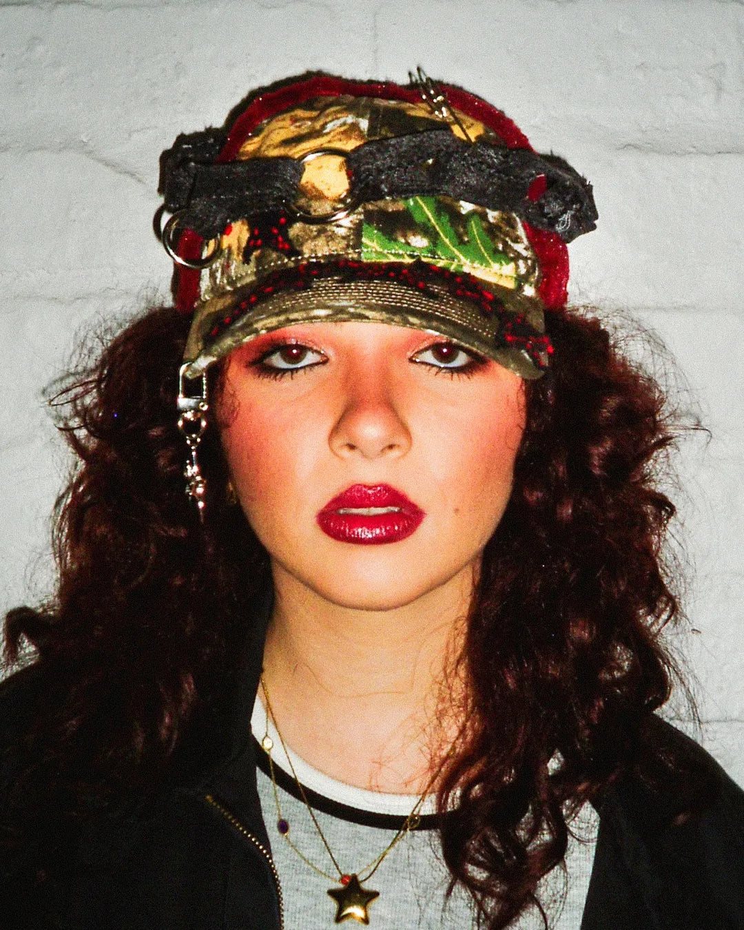 Person wearing a colorful cap with a textured background