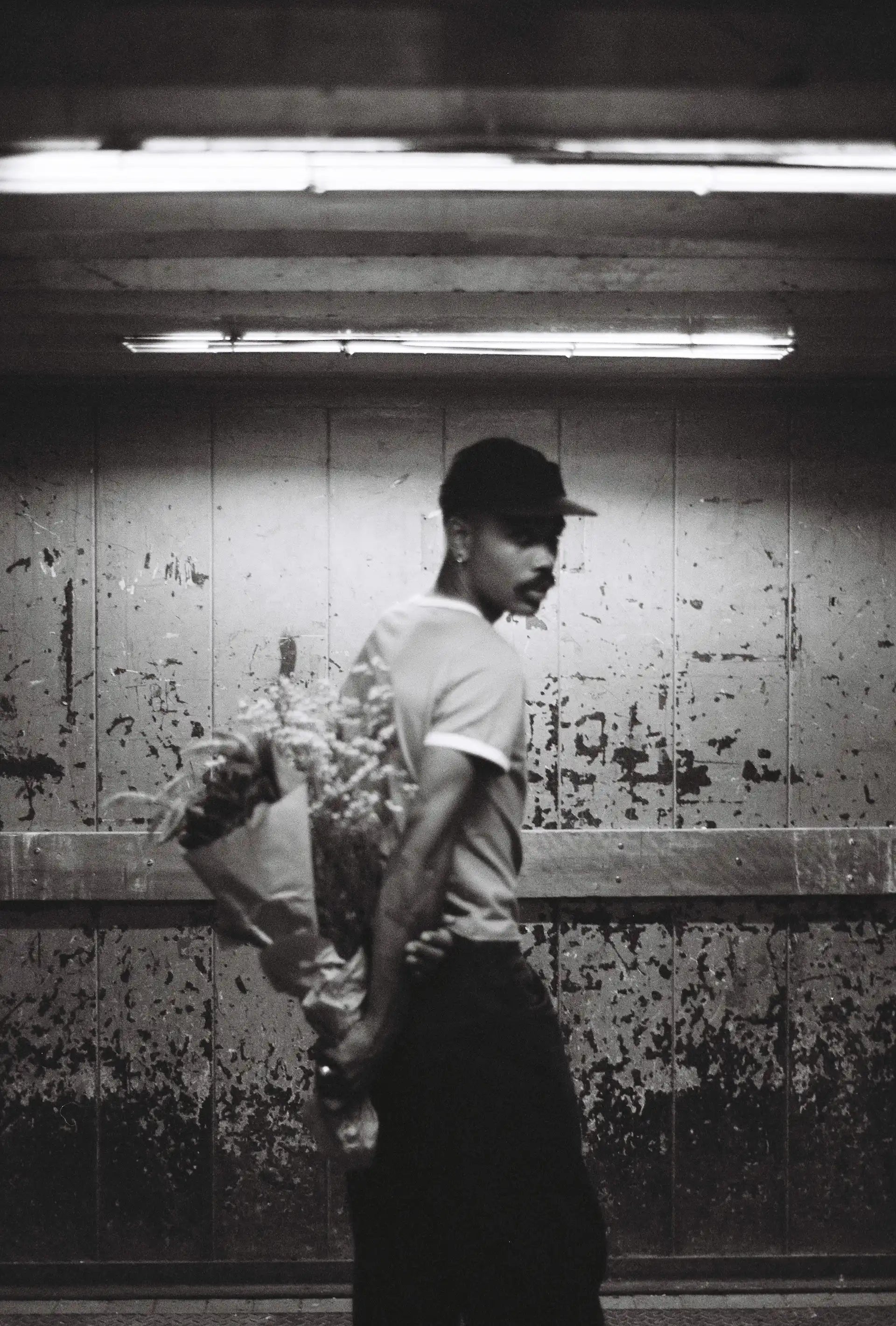 Grunge streetwear shoot with flowers and concrete background