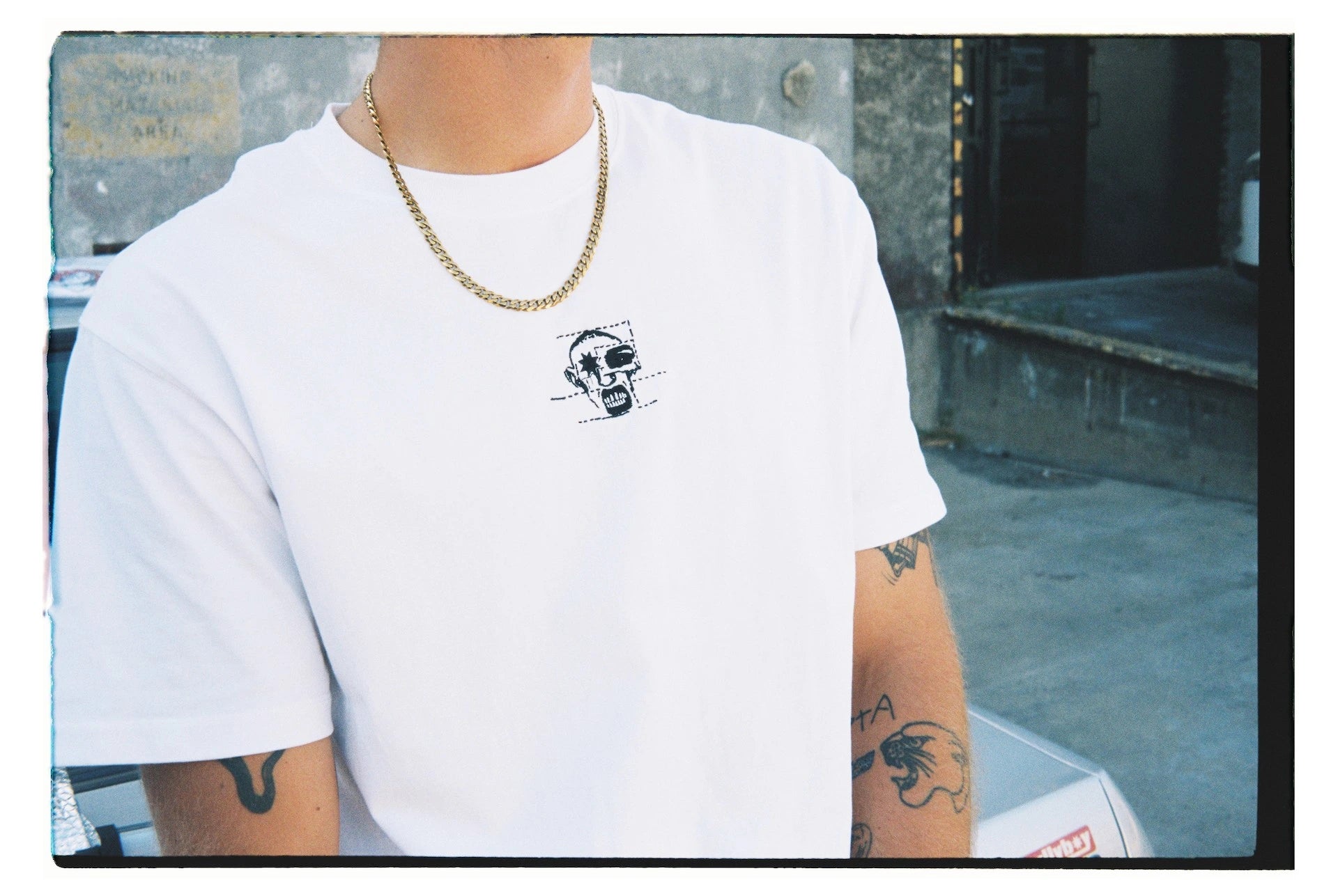 A tattooed man models a Bullyboy boxy tee, showcasing premium South African streetwear and a unique fashion statement