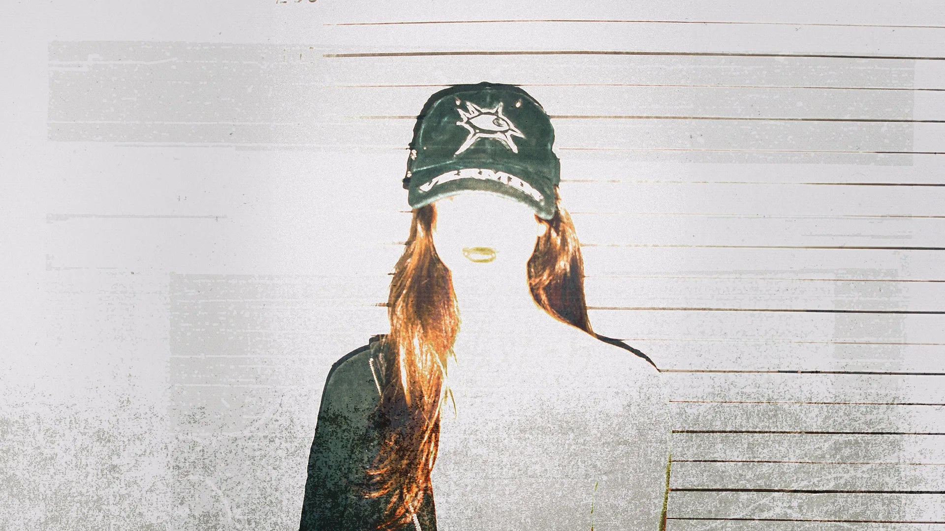 Person wearing a cap with a star design against a wooden background