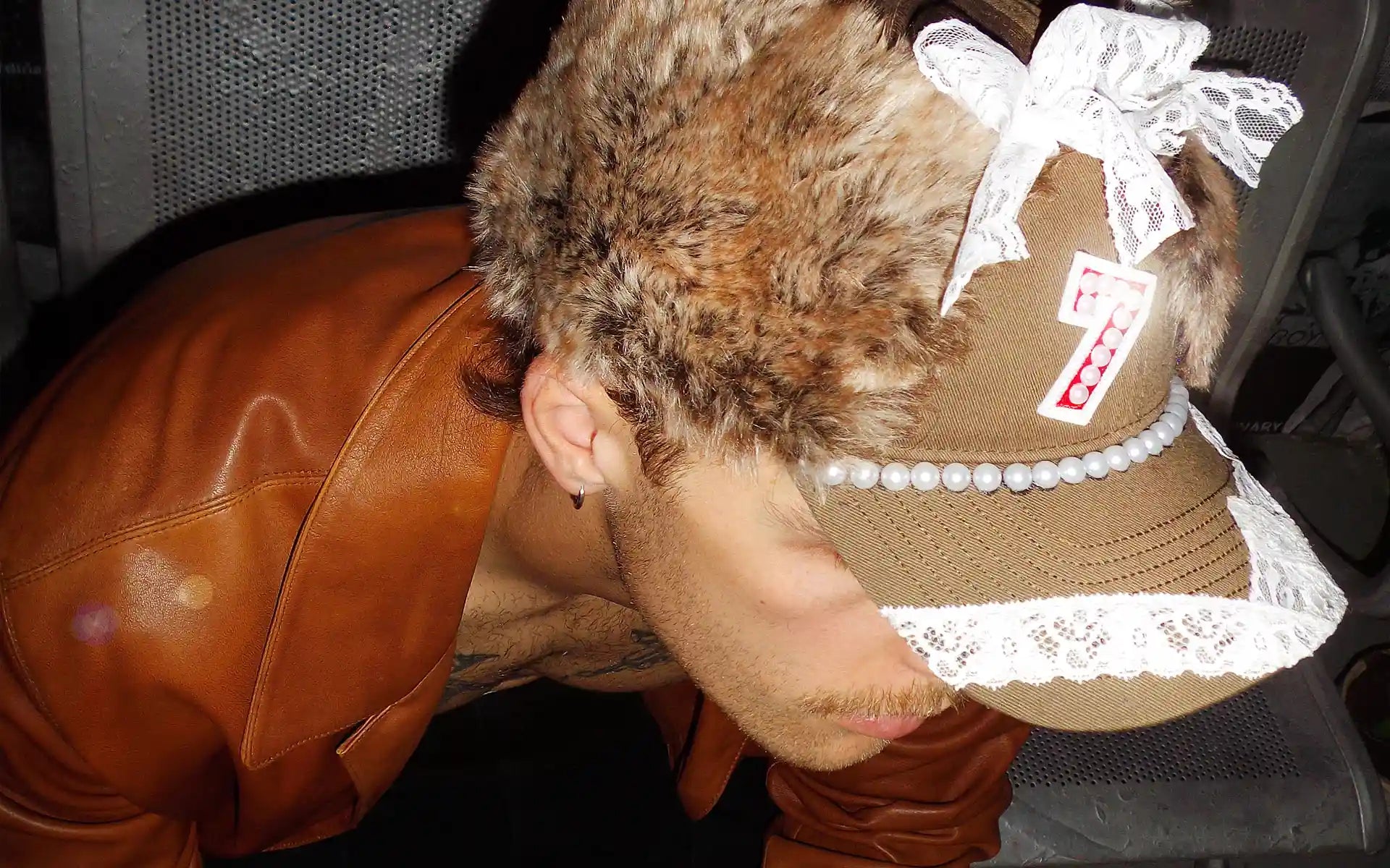 A luxury one of one brown Bullyboy cap decorated with faux fur, lace and pearls