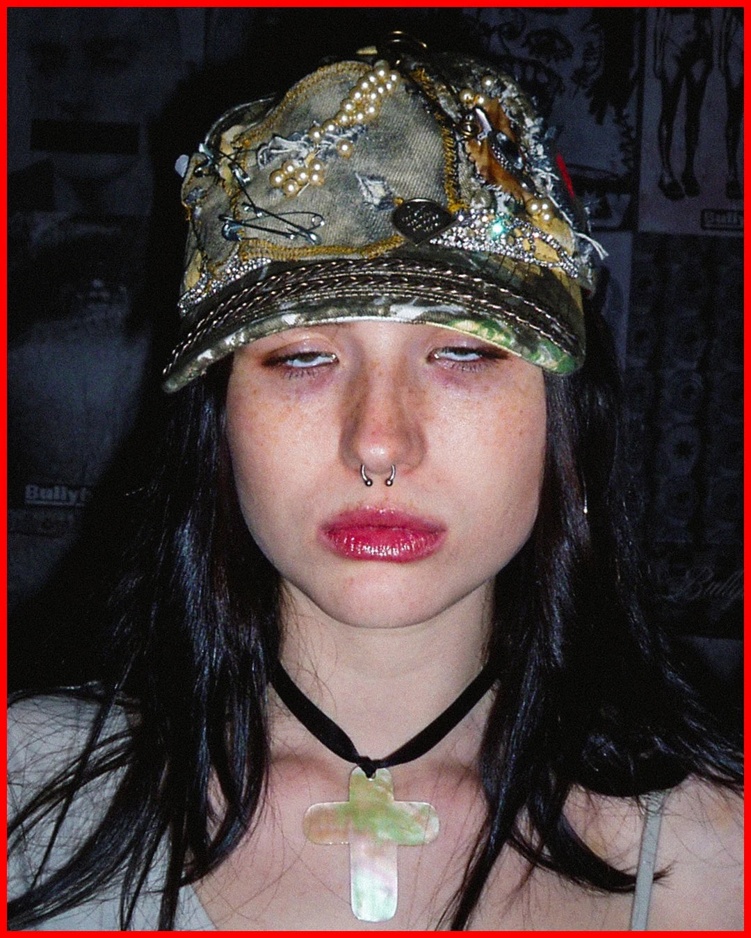Person wearing a decorated cap with a dark background