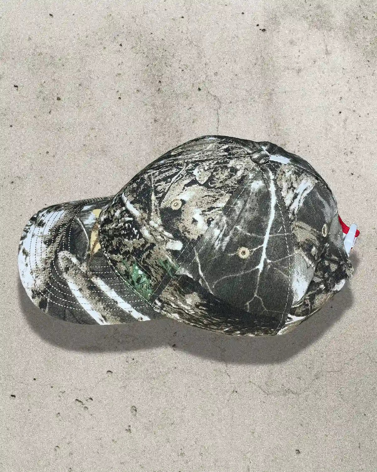 Side profile of camo Bullyboy cap showing structured fit and curved peak