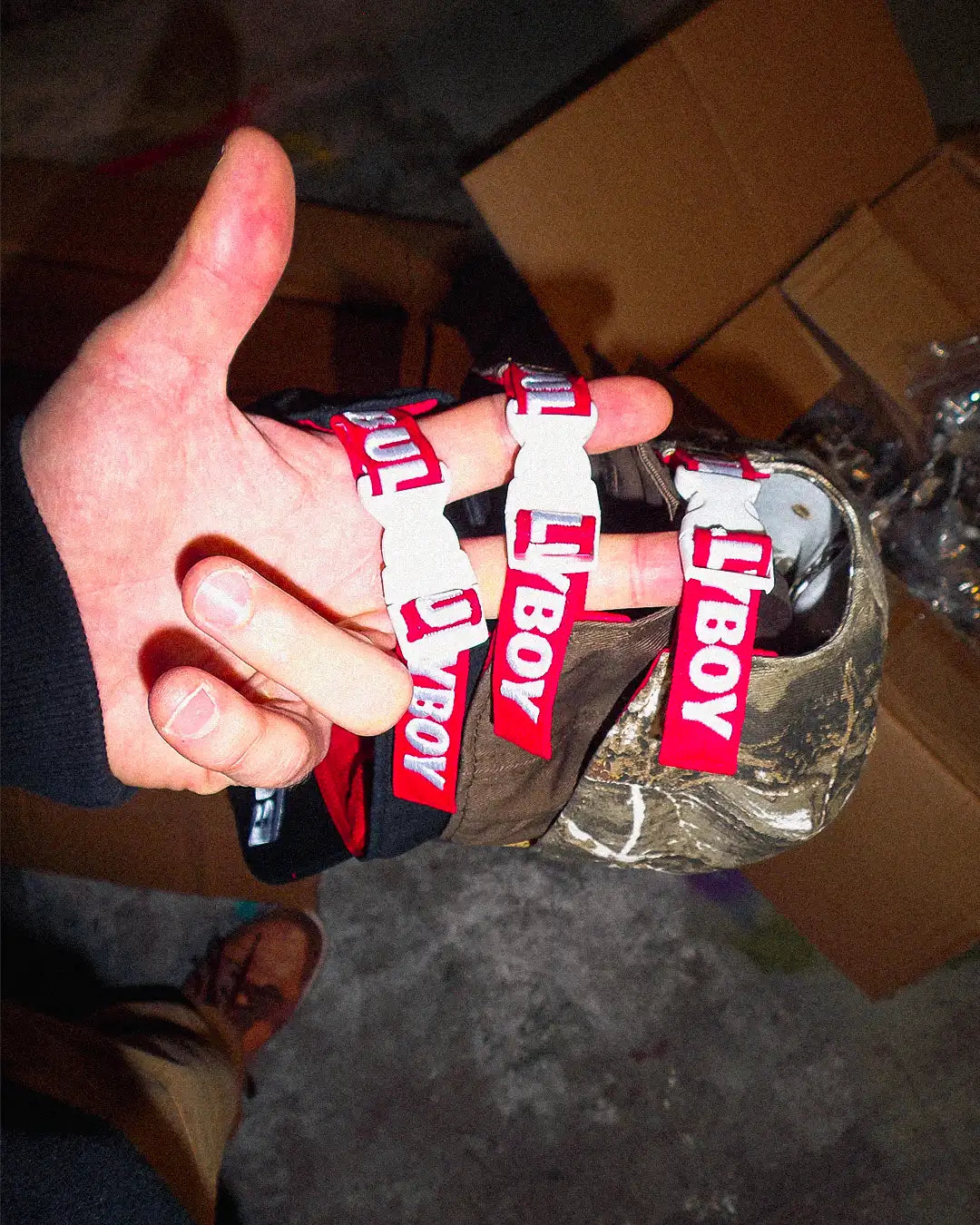 Back view of camo Bullyboy cap featuring red strap with white Bullyboy embroidery and white clamp