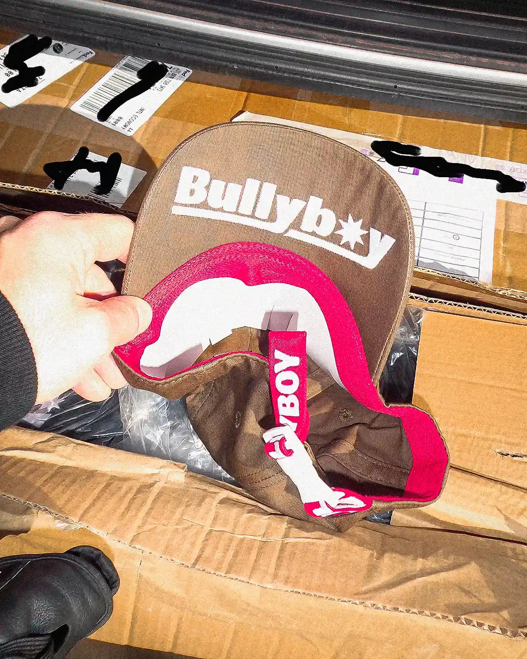 Macro shot of brown Bullyboy cap showing logo embroidery under brim and cotton fabric grain