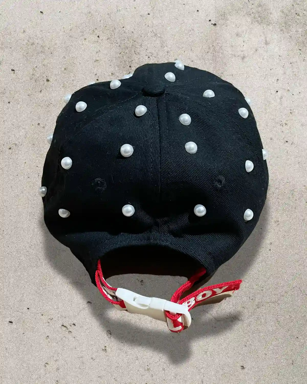 One-of-one luxury streetwear hat adorned with pearls and soft textures.