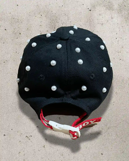 One-of-one luxury streetwear hat adorned with pearls and soft textures.