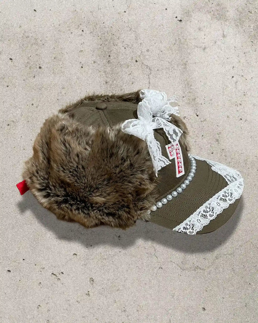 Handmade streetwear cap inspired by fairytales, featuring faux fur and a “7” patch.