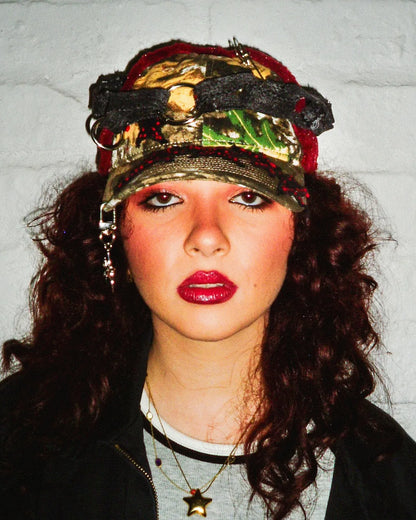 Person wearing a colorful cap with a textured background