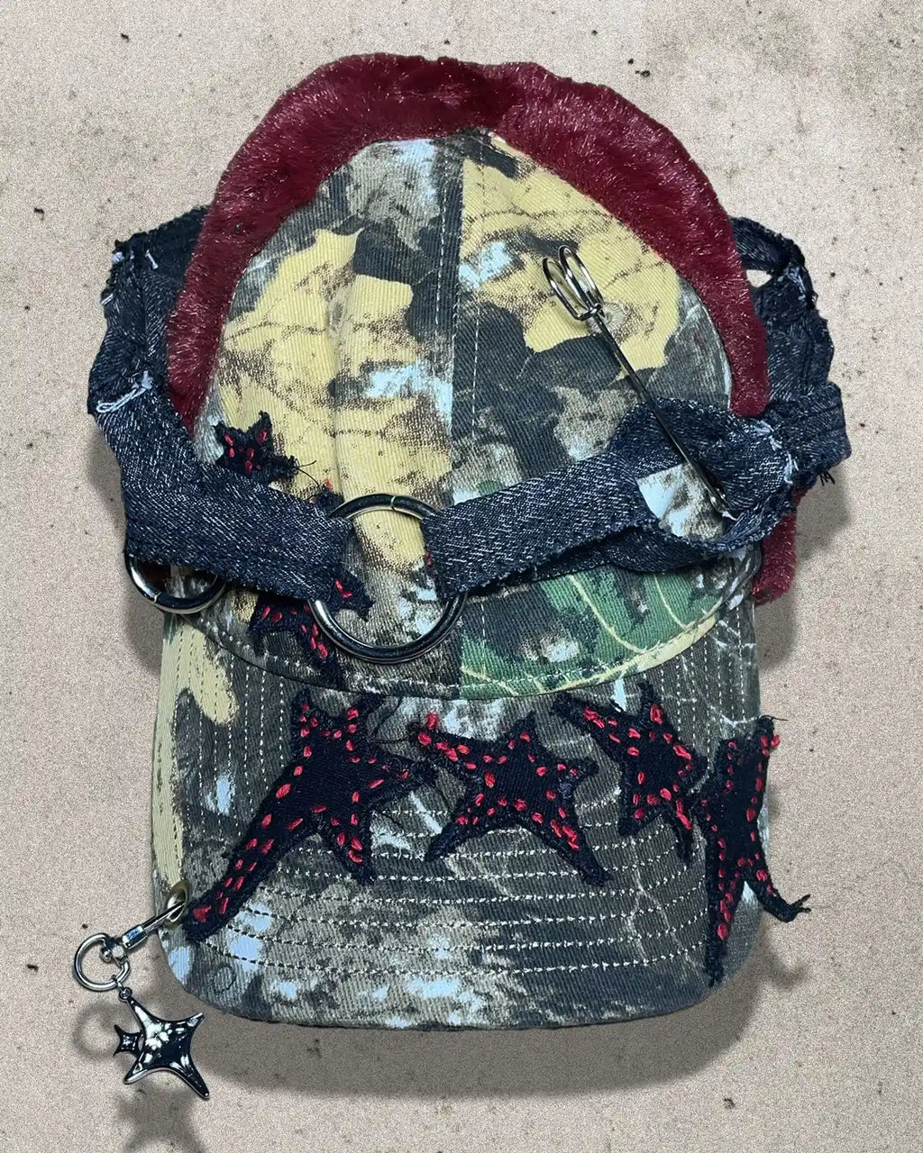 Camouflage pouch with red and black accents on a beige background