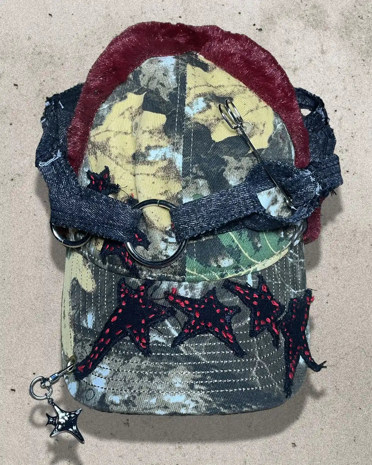 Camouflage pouch with red and black accents on a beige background