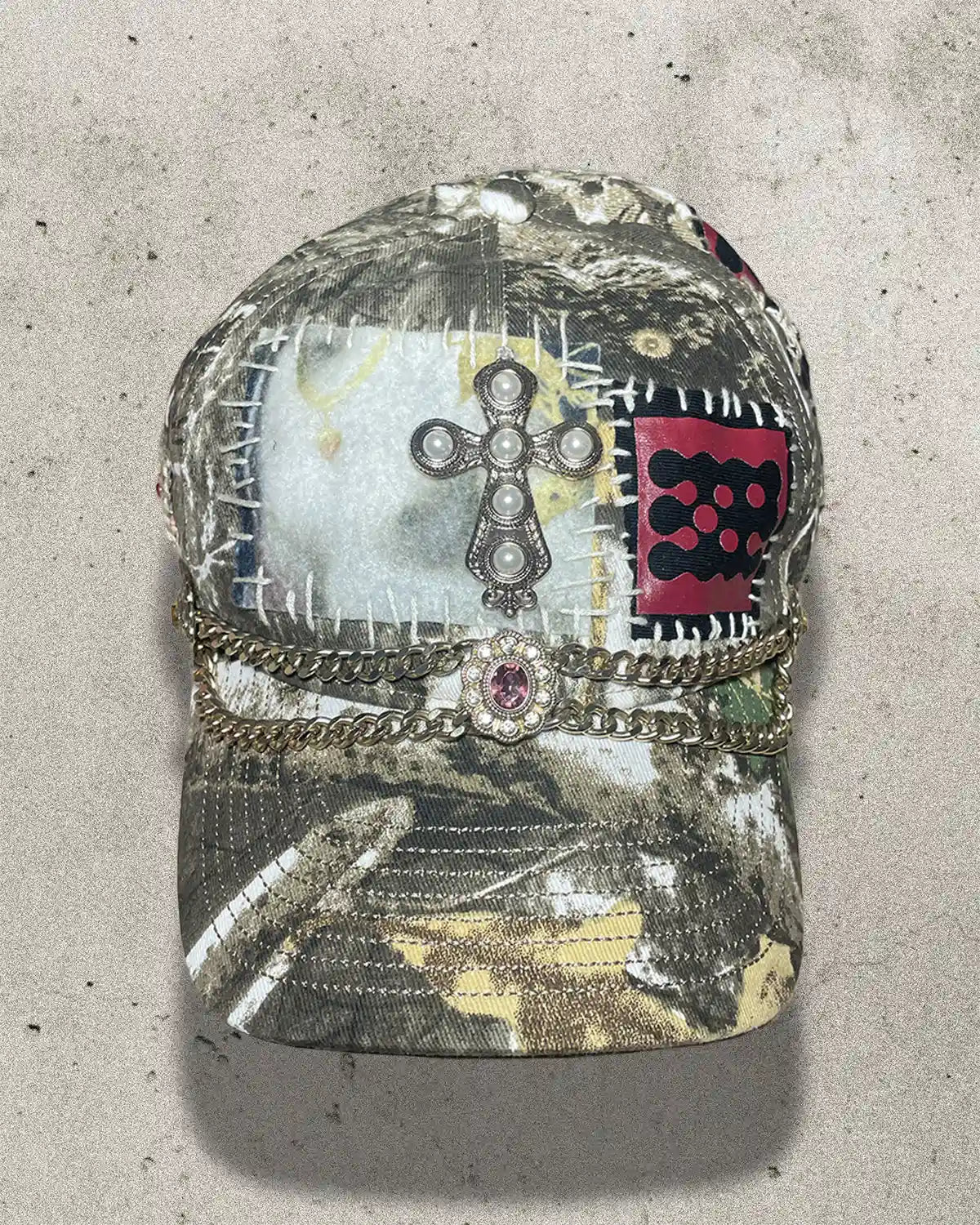 Camouflage cap with decorative elements on a concrete surface