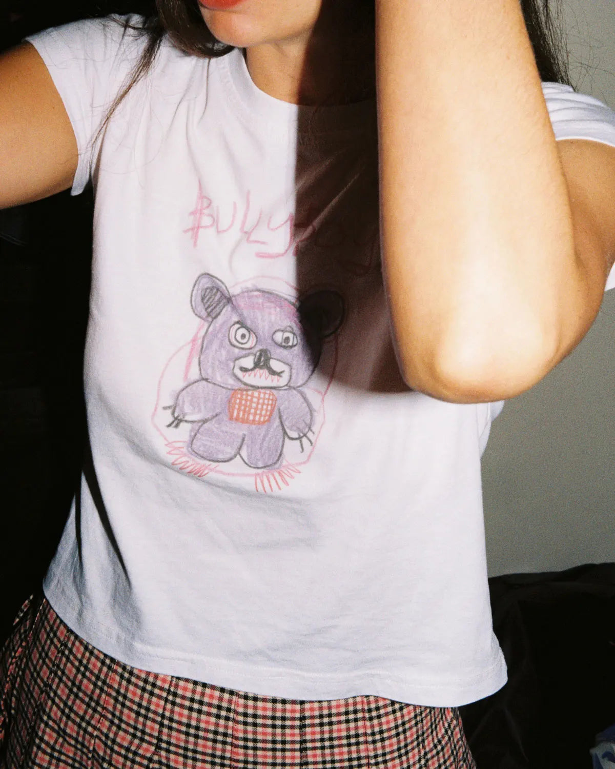 White 100% lightweight cotton female crop top with a teddy bear design on the front.