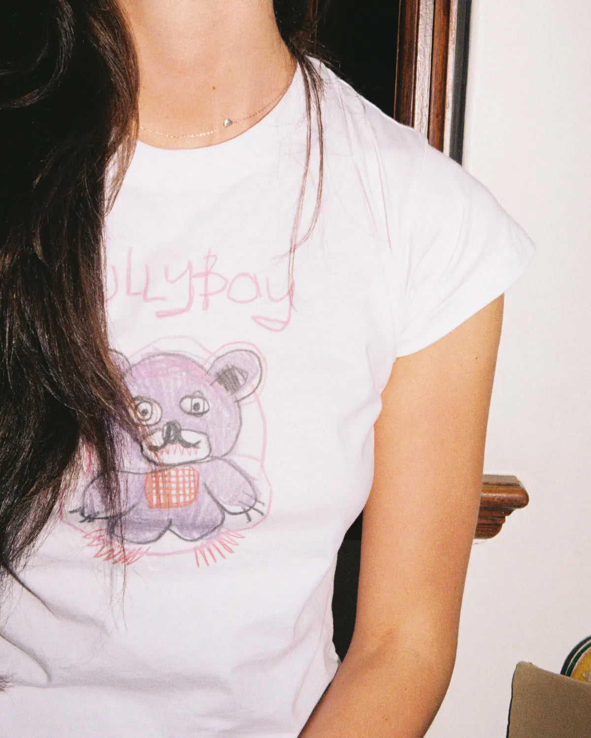 White 100% lightweight cotton female crop top with a teddy bear design on the front.