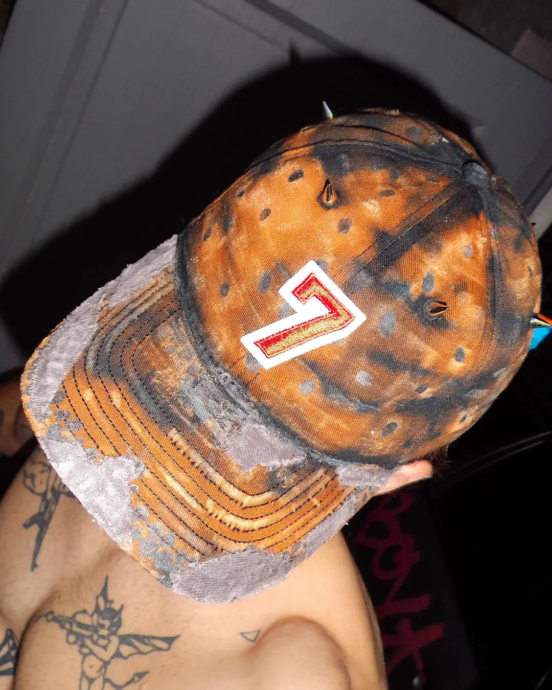 The new Bullyboy one of one dad cap with orange colors, distress marks, and silver accessories