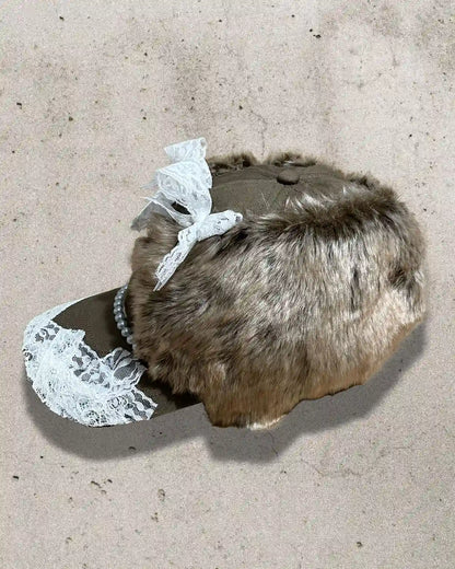 Brown furry cap with pearls, lace, and embroidered number 7 design.