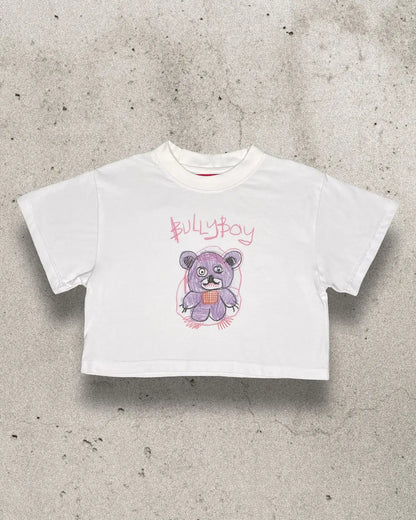 White 100% lightweight cotton female crop top with a teddy bear design on the front.