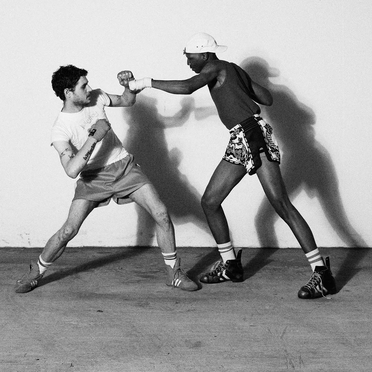 Two men in trendy shorts and sneakers clash in a fierce fight, highlighting Bullyboy's boxing-themed streetwear in Cape Town.