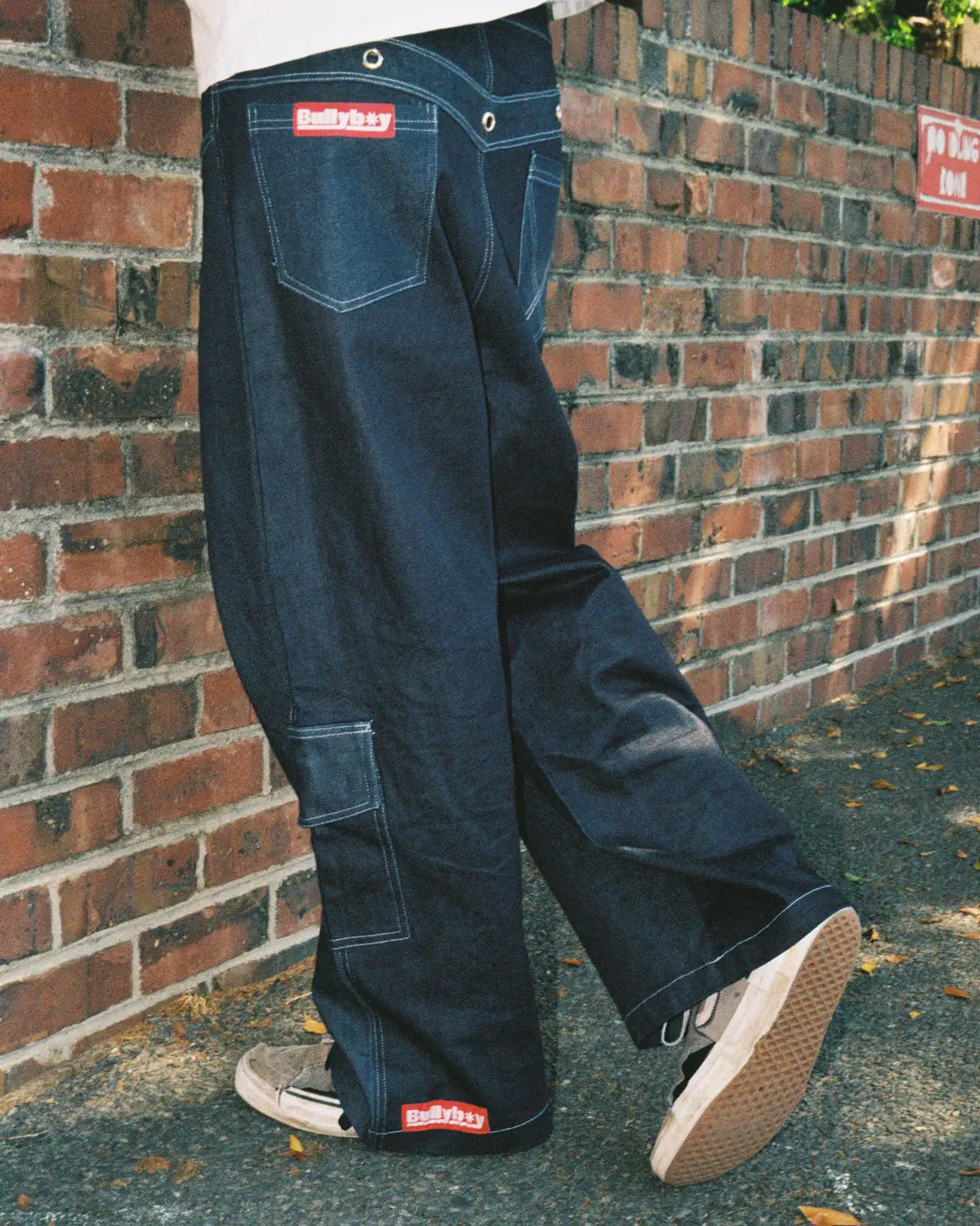  A man dressed in baggy jeans and sneakers, embodying the essence of unisex streetwear fashion